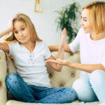 Conflict between mother and daughter. Sad little girl. Family problems. Social themes